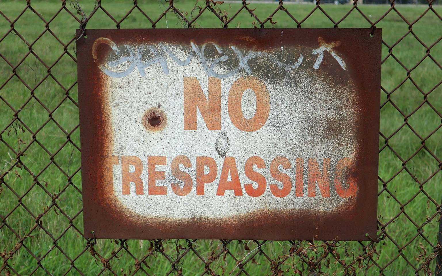 Photo by <a href="https://unsplash.com/@justin_ziadeh">Justin Ziadeh</a> on <a href="https://unsplash.com/photos/a-rusted-no-trespassing-sign-on-a-chain-link-fence-23W2jkVNIyo">Unsplash</a>